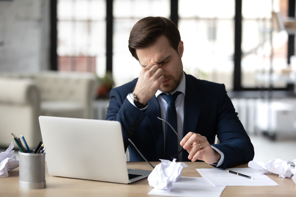 man overwhelmed with content creation